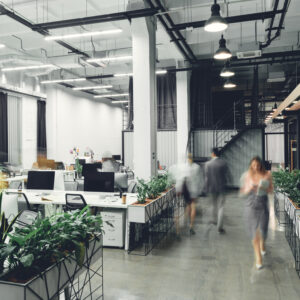 Contemporary office interior with blurred businesspeople in motion
